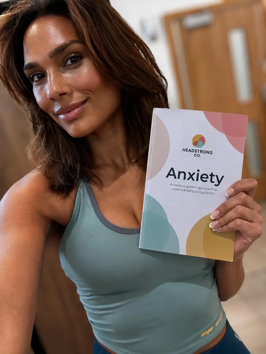 Jade, founder of Headstrong Co, holding the Anxiety Workbook